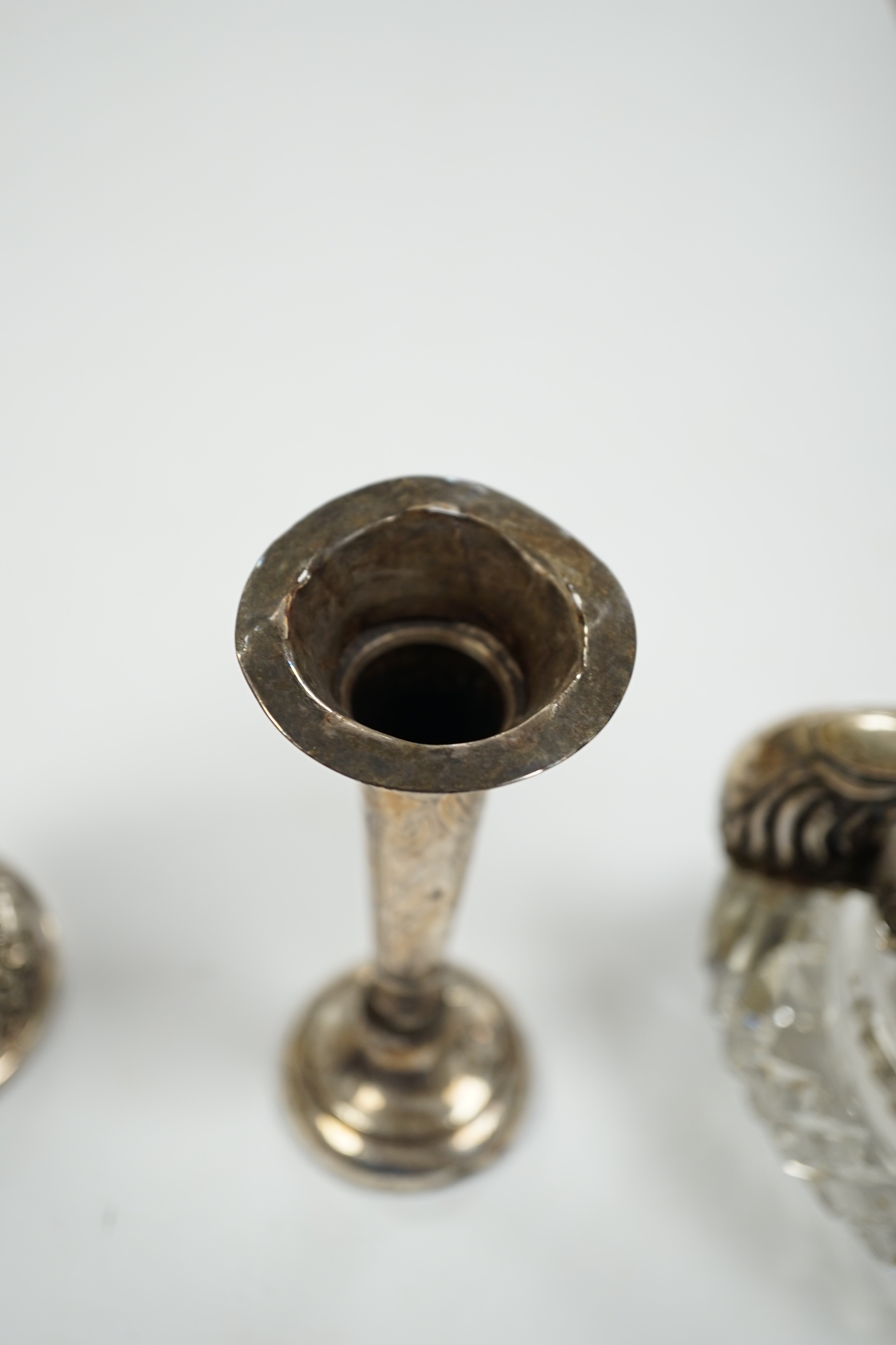 Two small white metal candlesticks, 8cm, an Indian vase, silver posy vase and a white metal mounted glass swan dish, a.f.